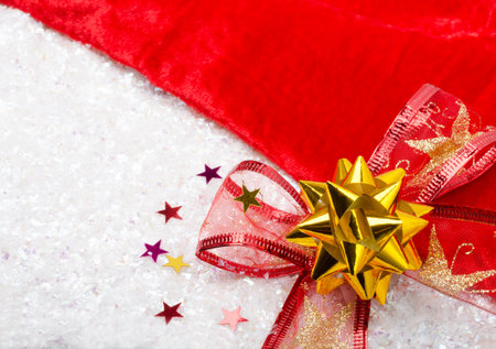 New Year and Christmas decorations for the holiday. Red bow, velvet and artificial snow. place for...