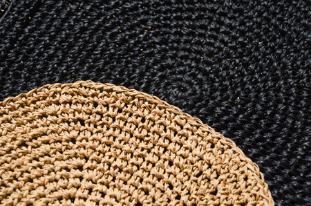 Raffia black and beige, crochet pattern. Wicker texture as a background.