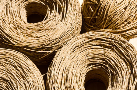 Raffia on a wooden background. Raffia is a 100% organic wood fiber that is easy to crochet.の写真素材