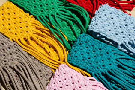 Small handbags knitted with macrame technique. Multicolored mobile phone bags.