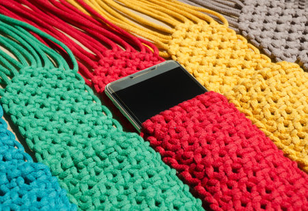 Small handbags knitted with macrame technique. Multicolored mobile phone bags.の写真素材