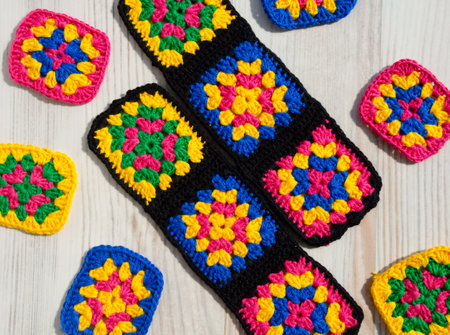 Handmade crocheted zigzag ornaments on gray background with copy space. Colorful cotton granny...