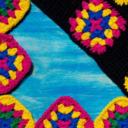 Colorful cotton granny square. Crochet texture close up photo. Knitted zigzag handmade jewelry. Place for text.の写真素材