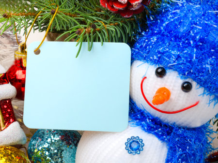 Christmas card. Snowman, green pine branches and Christmas tree toys. Place for text.の写真素材
