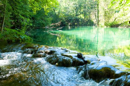 National park in Croatia Plitvice Lakes. Waterfall in a forest against the blue sky.の写真素材