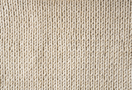 Beige knitted texture made of cotton thread. Handmade concept, hobby, background, fashionable online knitting course.の写真素材