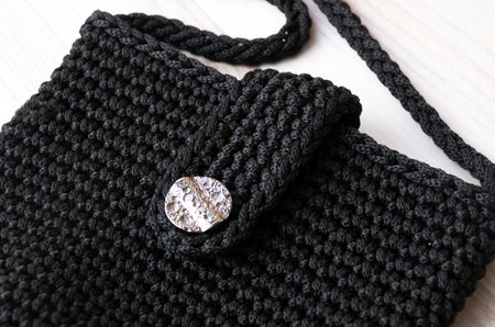 Polyester yarn. A small black handbag for the summer. Fragment of a women's handbag made of polyester cord.の写真素材