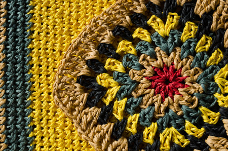 Raffia knitting texture close-up. Knitting from ECO material. Colorful raffia granny square. Hand knitted zigzag jewelry.の写真素材