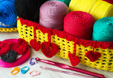 Polyester yarn in skins. Multi-colored polyester rolls in a wicker basket.の写真素材