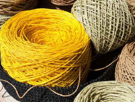 Raffia balls close-up on a burlap background. Raffia skeins are ready for knitting.
