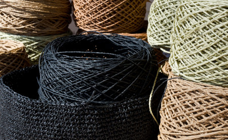 Raffia balls close-up on a burlap background. Raffia skeins are ready for knitting.