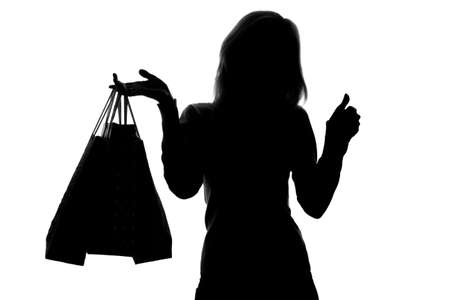 silhouette of a woman with shopping bagsの写真素材