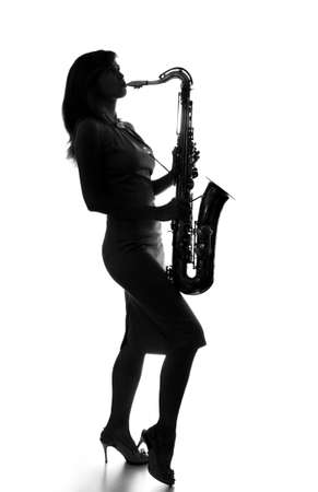 young woman playing the saxophoneの写真素材