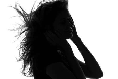 silhouette of a woman with headphonesの写真素材