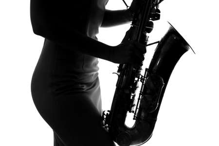 young woman playing the saxophoneの写真素材