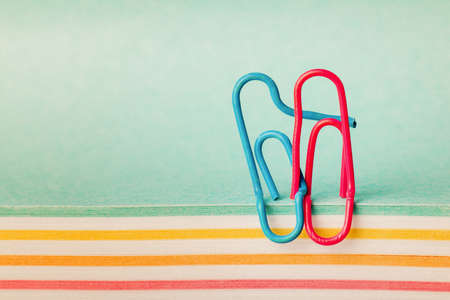 creative idea, the concept of happy relationships in the family, clips in the form of a hugging couple in loveの写真素材