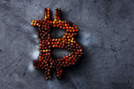 Burnt bitcoin sign on a metal texture, the concept of a crypto currency crashの写真素材