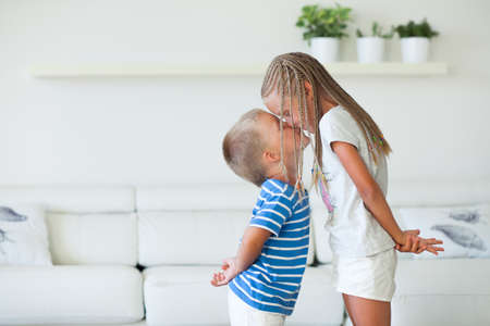 Boy and girl smiling and giving a kissの写真素材