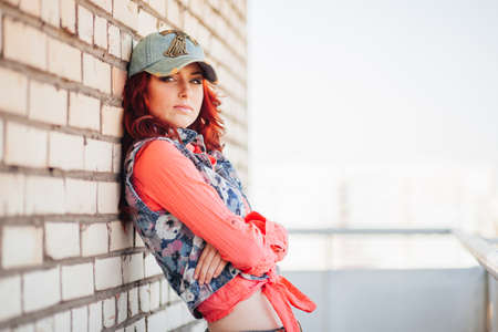 Beautiful redhair girl in casual on the rooftopの写真素材