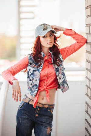 Beautiful redhair girl in casual on the rooftopの写真素材