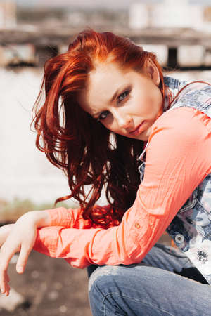 Beautiful redhair girl in casual on the rooftopの写真素材