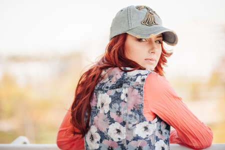 Beautiful redhair girl in casual on the rooftopの写真素材