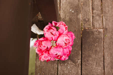 Flower bouquet of peony on wooden floorの写真素材