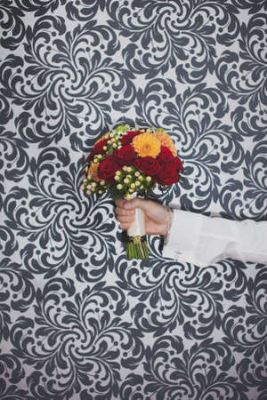 A bouquet of flowers in hand on the black-white backgroundの写真素材