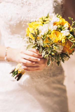 Bride holding the beautiful bouquet of flowersの写真素材