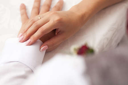 Bride and groom hands on one anotherの写真素材