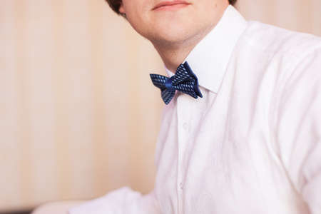 Handsome man in white shirt with blue bowtieの写真素材