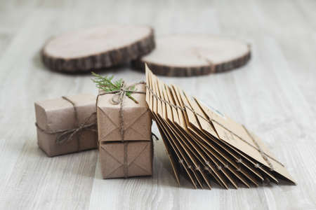 Pack of letters with box of presents and wooden pieces in the background