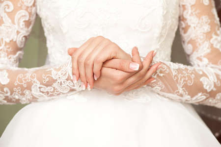 Beautiful bride's hands on one anotherの写真素材