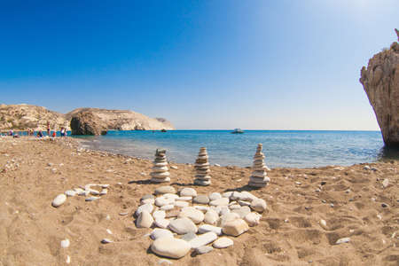 Beautiful sea shore landscape, sea, cliffs, stone pyramids, boat, stone heart