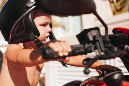 Boy holding the bike steering close-up outdoor in summerの写真素材