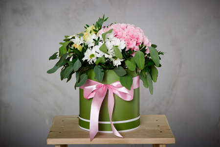 A bunch of pink and white flowers with soft linen on the boxの写真素材