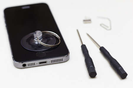 Close-up photos showing process of mobile phone repair, changing the screen.