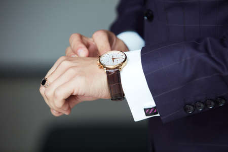 Man's hands with watches and studs close-upの写真素材