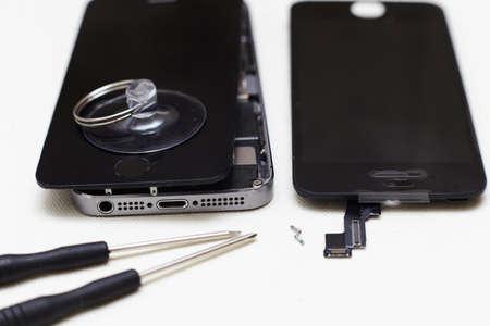 Close-up photos showing process of mobile phone repair, changing the screen.の写真素材