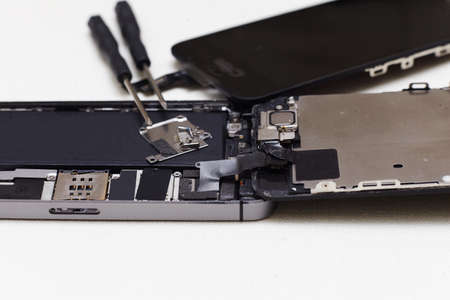 Close-up photos showing process of mobile phone repair, changing the screen.の写真素材