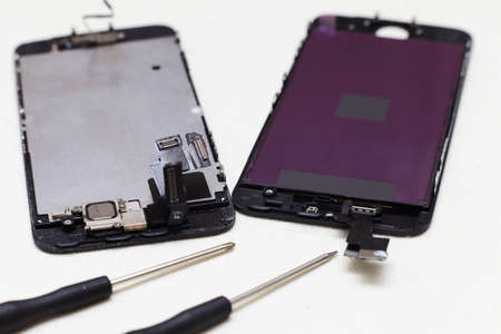 Close-up photos showing process of mobile phone repair, changing the screen.の写真素材