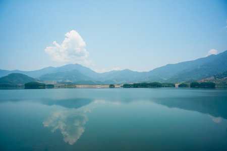 beautiful view of mountain hills and lake water under cloudy blue sky 1の写真素材