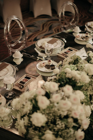 luxury wedding dining table decoration with white roses and dim light 1の写真素材