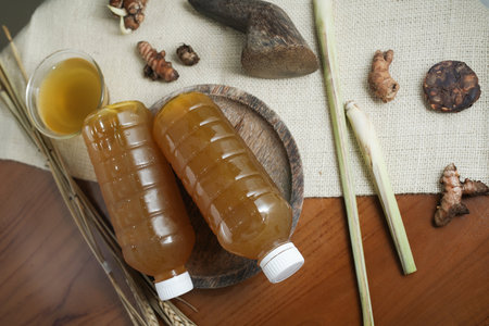 Plastic bottle containing fresh herbal drink with spices in a mortar. Traditional health drink made from natural ingredients. Top view (2)の写真素材
