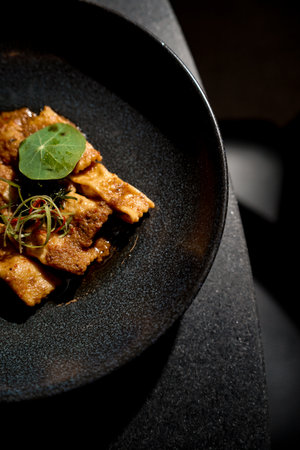 grilled fish dish with spices on a plate on the dining tableの写真素材