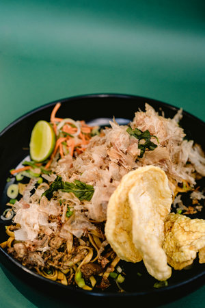noodle dish topped with dried skipjack tuna shavings, served with sliced carrots, cucumber, spring onions, and lime, and crackers. Japanese food (2)の写真素材