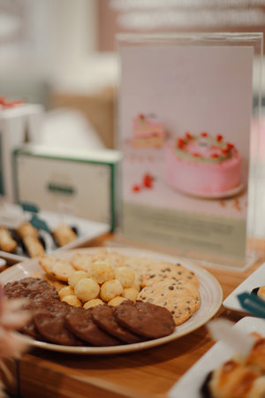 Various delicious cookies on plates on a wooden table. Light snack foodの写真素材