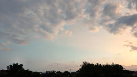 sunset sky with houses and trees below, natural beauty, landscapeの写真素材