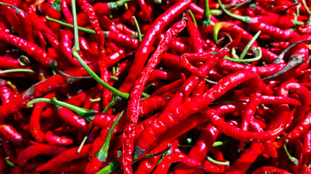 Pile of hot curly red chilies. Cooking spices and food flavorings. Harvest (1)