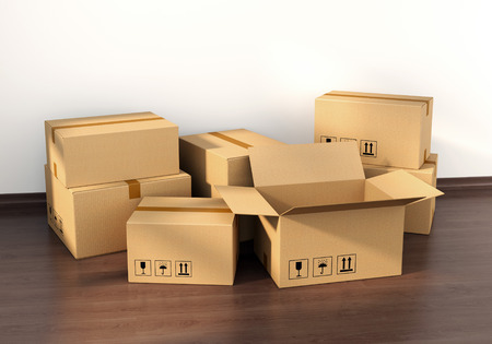 Cardboard boxes on wooden floor in new house interior. Housing, real estate and moving concept.の写真素材